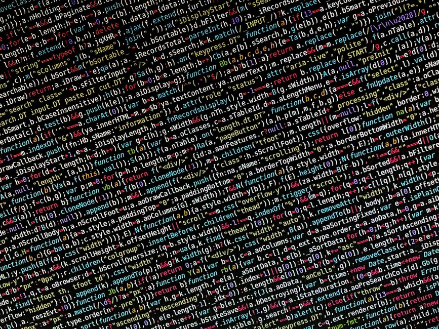 A close-up photograph of a computer screen displaying lines of HTML and CSS code with various tags, attributes, and colour-coded syntax, including script elements referencing images and classes relate
